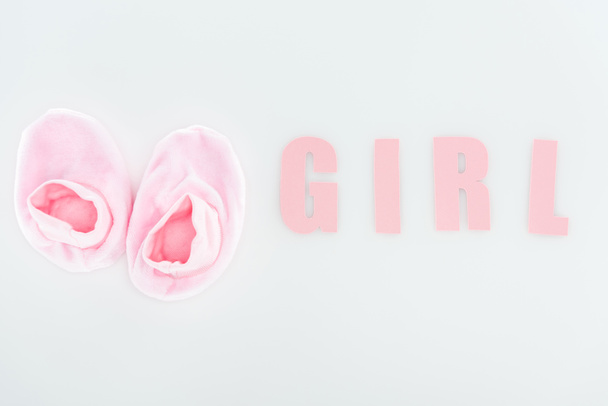 top view of pink booties and girl lettering isolated on white with copy space - Foto, Bild