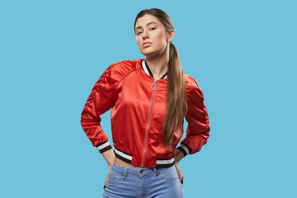 Youth style. Portrait of model in bright red bomber. - Fotó, kép