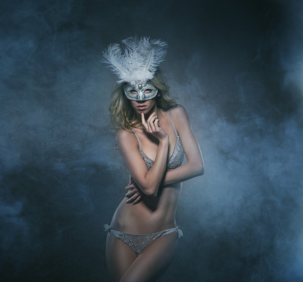 Young sexy woman in erotic lingerie and mask over the luxury bac - Foto, immagini