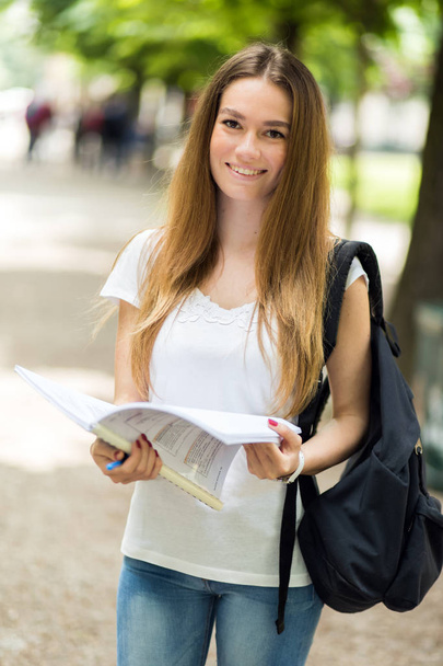 Smiling female student outdoor - Photo, image