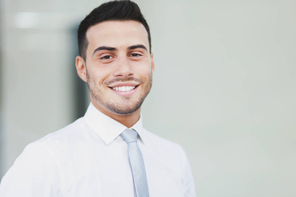 Portrait of young businessman smiling  - Fotó, kép