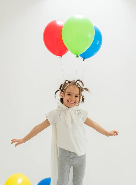 Happy boy with a bunch of balloons  - Valokuva, kuva