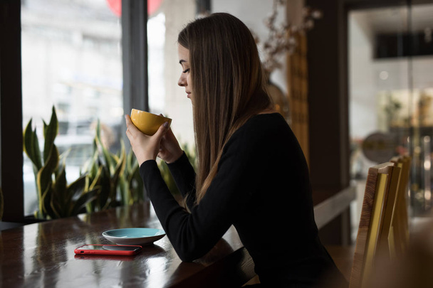 Woman having coffee break sitting in cafe - Foto, Imagen