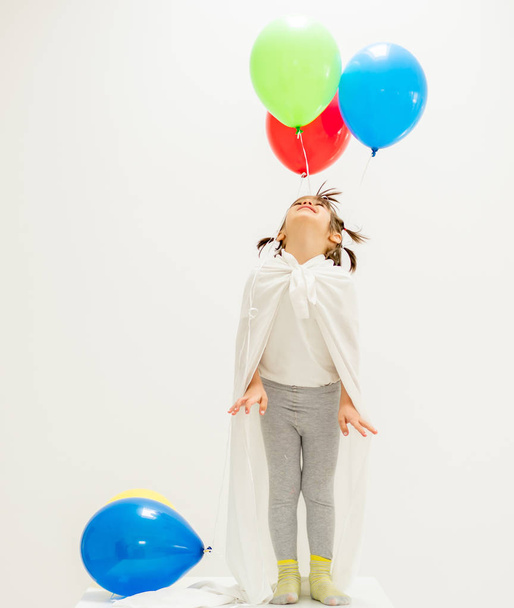 Happy boy with a bunch of balloons  - 写真・画像