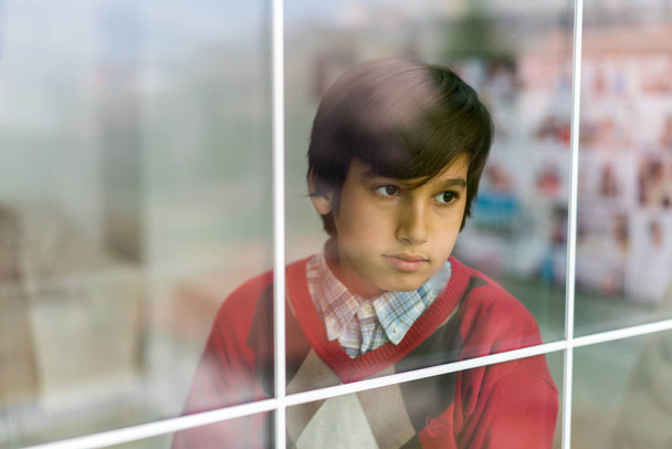 Happy boy behind window glass - Foto, Imagen