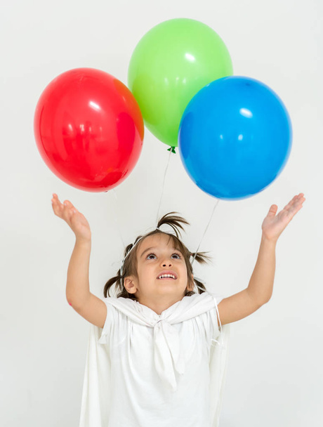 Happy boy with a bunch of balloons  - Фото, изображение