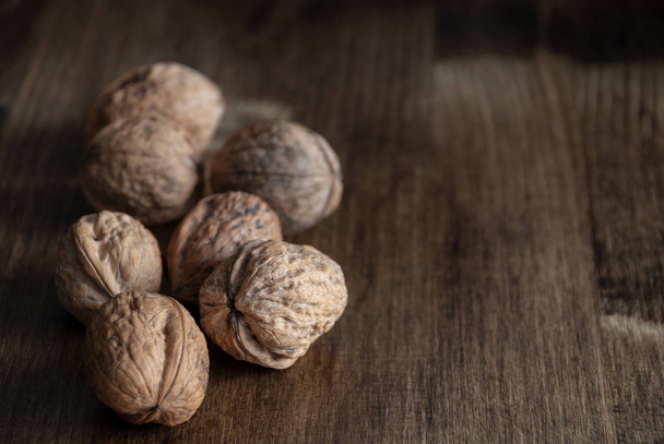 Walnuts on dark wood background with copy space - Photo, Image