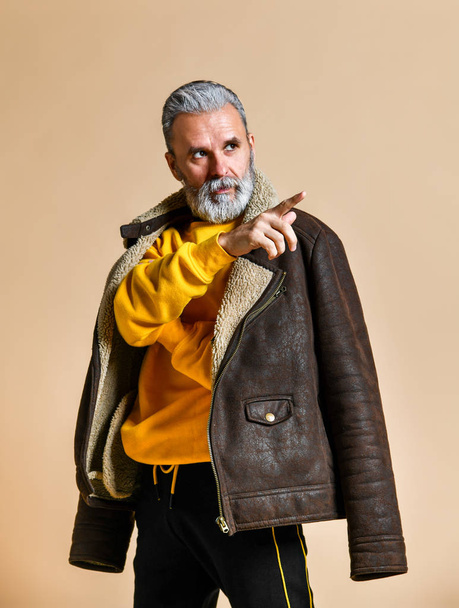 senior stylish rich man with a beard and mustache in a leather coat - Fotoğraf, Görsel