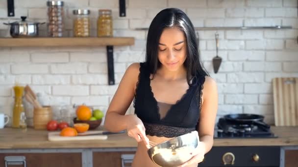 Attractive young woman cooking at the kitchen. - Video