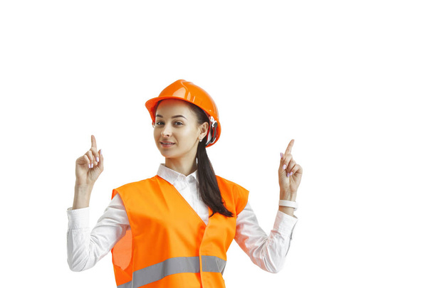 The female builder in orange helmet isolated on white - Фото, зображення