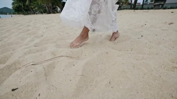 Barefoot woman walking on beach sand - Video