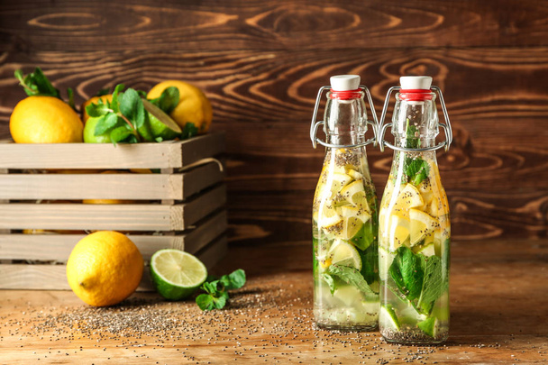 Bottles of infused water on wooden table - Photo, Image