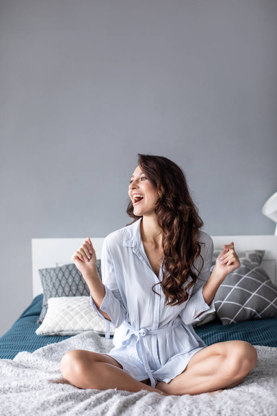 Happy woman on the bed at home. - Foto, Imagen