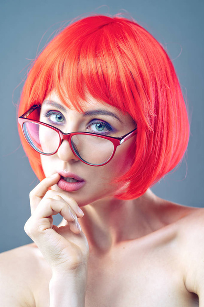 Tricky beauty. Woman in red wig and eyeglasses. - Fotó, kép