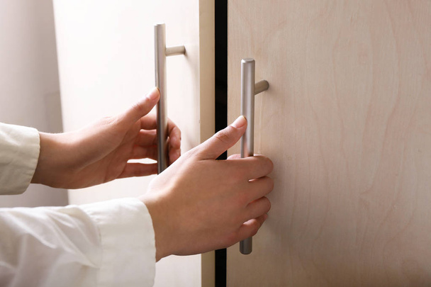 Руки женщины открывают дверь, крупным планом. Концепция начала новой карьеры
 - Фото, изображение