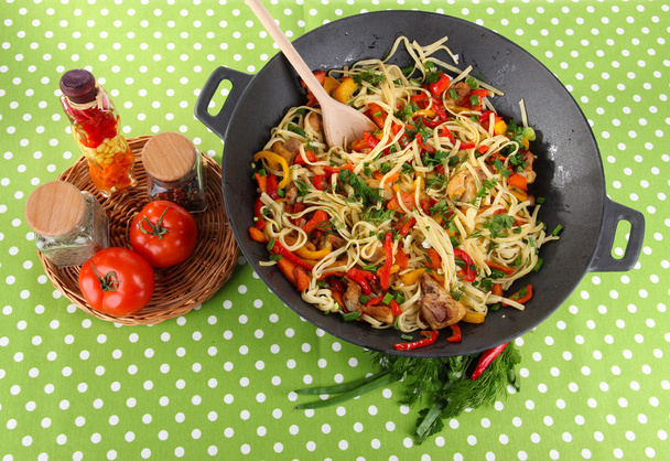Noodles with vegetables on wok on cloth background - Foto, Imagen