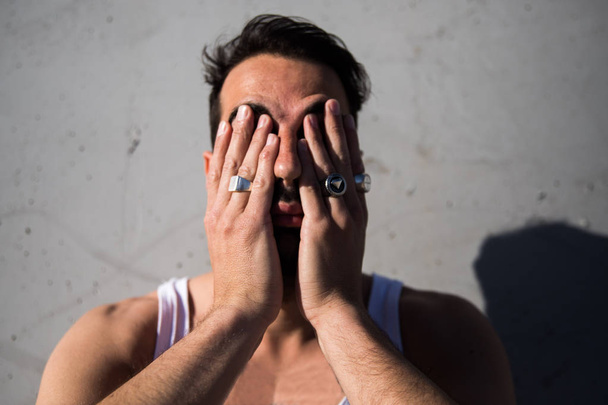 portrait of handsome man covering face with hands - Photo, Image
