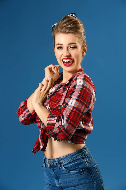 Playful pin-up woman on color background - Foto, afbeelding