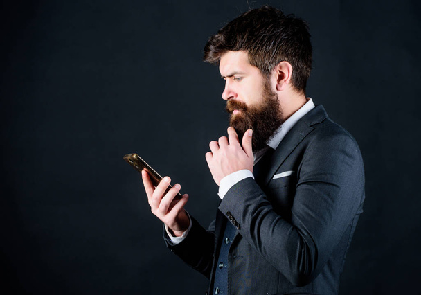 Looking for design inspiration online. businessman in suit. brutal caucasian hipster with moustache. Mature hipster with beard speak on phone. online and agile. Bearded man with smartphone - Photo, image