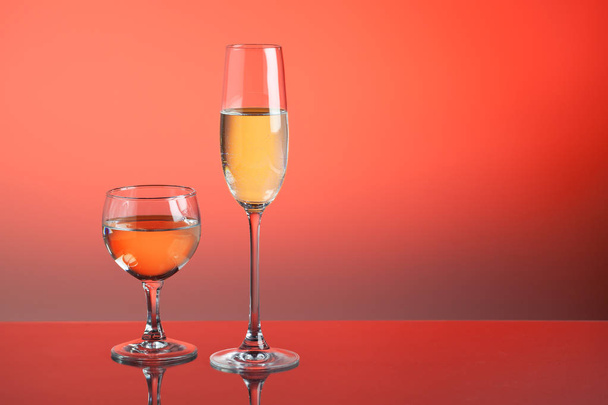 close-up view of glasses with drinks on red background - Фото, изображение