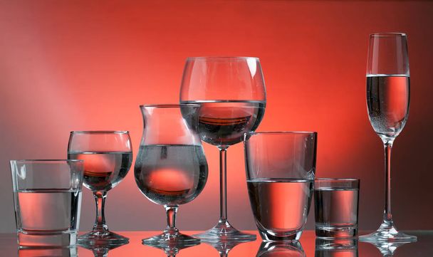 close-up view of glasses with drinks on red background - Fotografie, Obrázek