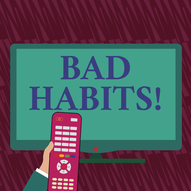 Text sign showing Bad Habits. Conceptual photo someone do negative behaviour pattern like smoking stereotyping Hand Holding Computer Remote Control infront of Blank Wide Color PC Screen. - Photo, Image