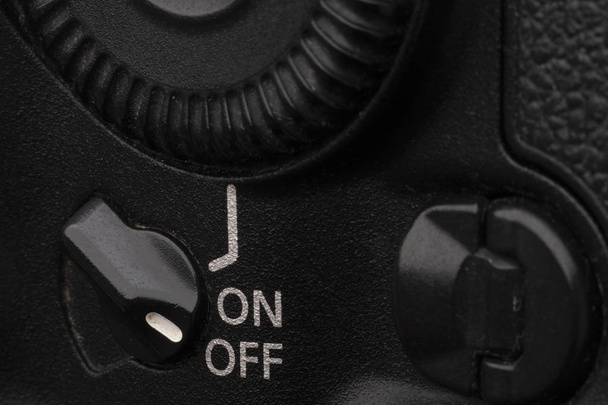 Close-up macro shot of a modern digital SLR camera. Detailed photo of black camera body with a classic wide aperture portrait lens - Foto, Imagem
