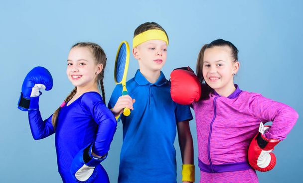 Great progress. Happy children in boxing gloves with tennis racket and ball. Fitness energy health. punching knockout. Team sport success. workout of small girls boxer and boy in sportswear - Fotó, kép