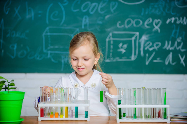 School education. Interesting approach to learn. Future scientist. Explore and investigate. School lesson. Girl cute school pupil play with test tubes and colorful liquids. School chemical experiment - Foto, immagini