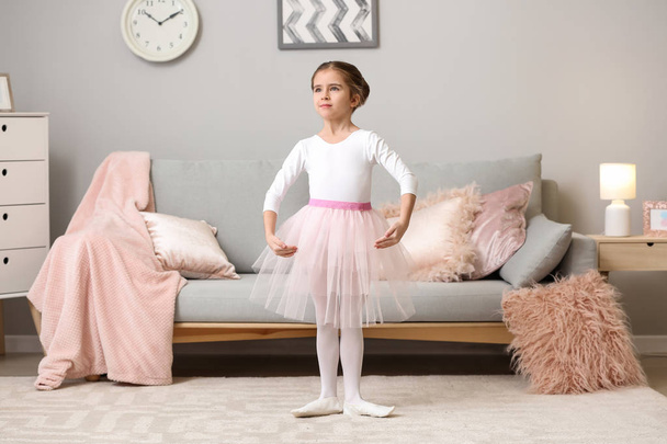 Cute little ballerina dancing at home - 写真・画像