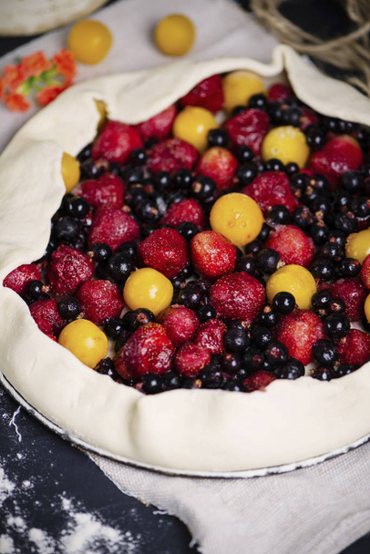 homemade puff pastry pie with cherry plums, blueberries and strawberries - 写真・画像