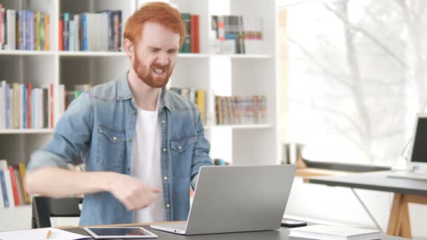 Rento punapää mies selkäkipu työskentelee kannettavan tietokoneen
 - Materiaali, video