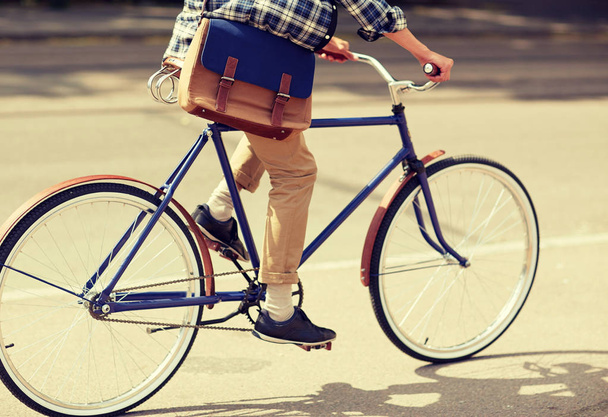 young hipster man with bag riding fixed gear bike - Foto, Imagen