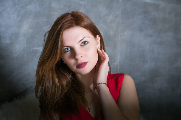 portrait of a pretty girl with in red dress with red hair - Fotografie, Obrázek