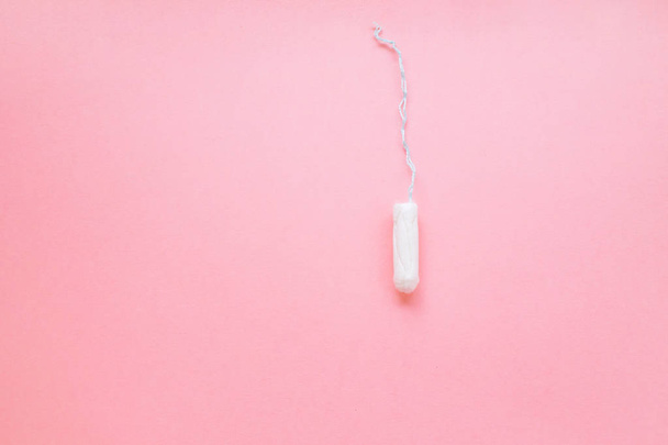 women intimate hygiene product - sanitary tampon on pink background. - Photo, Image