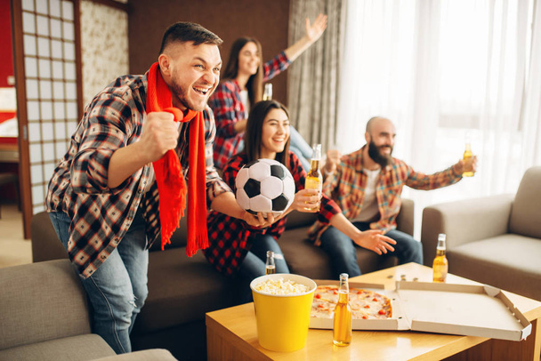 Friends wathing tv broadcast at home, football fans. Group of people cheer for their favorite team, decisive match. Cheerful company celebrate goal - Φωτογραφία, εικόνα