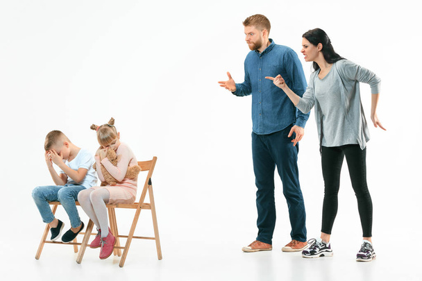 Angry parents scolding their children at home - Fotó, kép