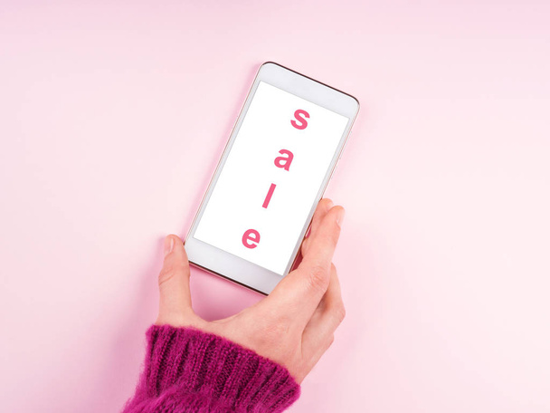 Mobile phone screen on pink. Sale offer - Photo, image