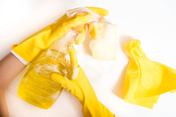 Cleaning concept - mixed detergents and cleaning accessories isolated on blue seamless background. - 写真・画像