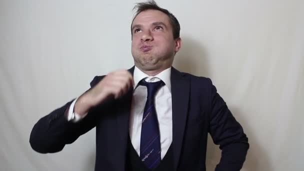 A young handsome businessman closes his nose with his fingers feeling a bad smell. - Video