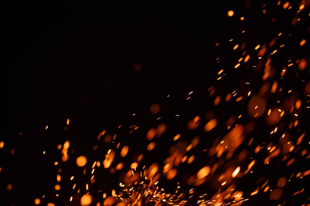 Sparks of a fire on a black background. - Photo, Image