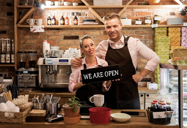 Couple in their new cafe, proud news business owners - Foto, immagini