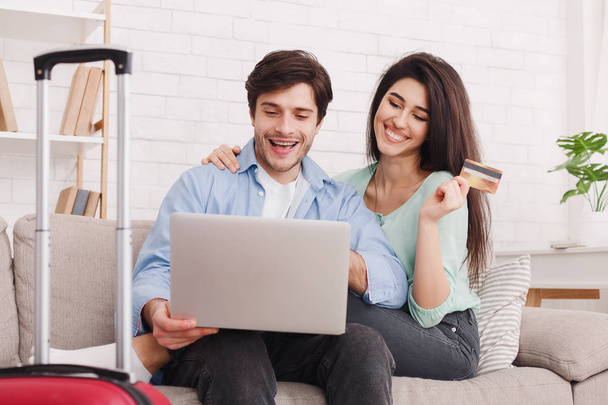 Romantic couple preparing for travel, using laptop - Zdjęcie, obraz