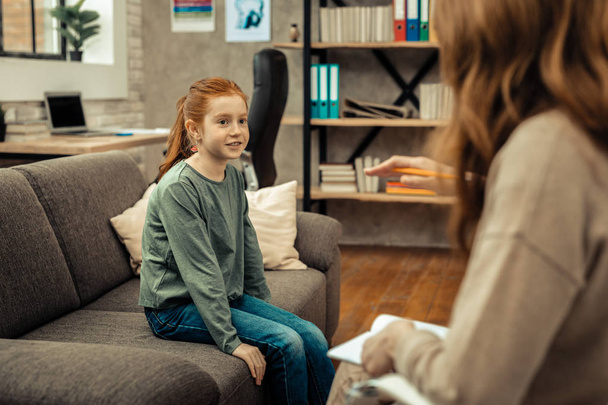 Cute positive girl looking at her therapist - Photo, image