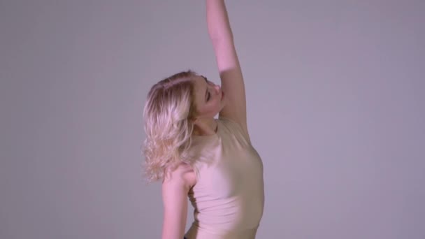 Beautiful blonde girl dancing slow classical dance in slow motion - Metraje, vídeo