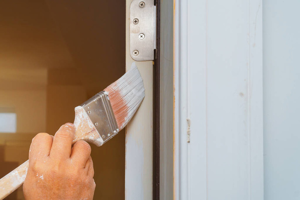 Man is painting door with brush - Foto, Bild