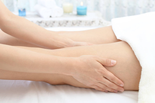 Close-up of leg receiving massage in spa - Photo, Image