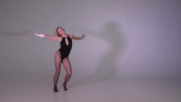 A yound attractive happily dancing in studio in slow motion - Imágenes, Vídeo