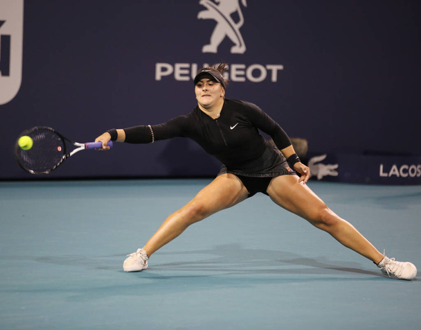 MIAMI GARDENS, FLORIDA - MARCH 23, 2019: Professional tennis player Bianca Andreescu of Canada in action during her round of 32 match at 2019 Miami Open at the Hard Rock Stadium in Miami Gardens, Florida - 写真・画像