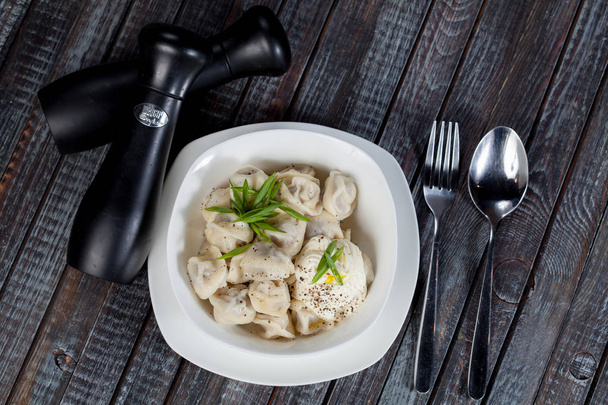 real, delicious, Russian dumplings on the table, with fresh herbs and spices, for cooking design. - Φωτογραφία, εικόνα